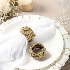 two napkin rings sitting on top of a white plate