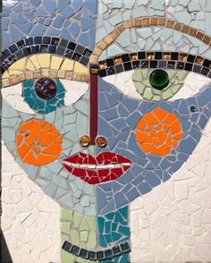 a close up of a face made out of mosaic tiles