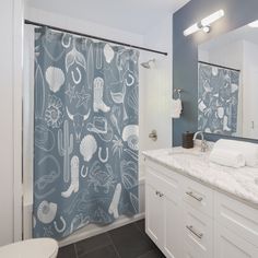 a bathroom with blue and white shower curtain in it's center, next to a toilet