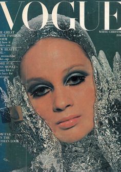 a magazine cover with an image of a woman wearing silver gloves and headdress