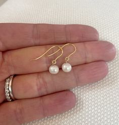 Freshwater pearls hung simply from solid 9ct gold ear wires. Delicate and classic. Pearls are the birthstone of the June born. These earrings are also available in sterling silver, gold filled and rose gold filled. They come in a beautiful gift box ready for gifting. According to history, pearls are symbolic of wisdom gained through experience. The gems are believed to offer protection, as well as attract good luck and wealth. They are well-known for their calming effects. Gold Pearl Earrings, June Birthstone, Jewelry Inspo, June Birth Stone, Beautiful Gift Boxes, Gold Pearl, Ear Wires, Or Rose, Fresh Water