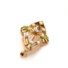 FREE shipping on all orders! FREE 5 Day Returns! Learn More. Part of our Vintage Collection, a spectacular American Art Nouveau Krementz brooch. The 14K yellow gold brooch features a filigree oval setting with green enameled leaves dotted with seed pearls. A prong set old European cut diamond adorns the center. Brooch or Pin Closure Type: C Clasp with Safety Clasp Hallmark: 14K and Krementz Trademark Designer: Krementz Era: Art Nouveau Total Weight: 2.80 dwt Center Diamond: (1) Old European Cut, Art Nouveau Enamel Brooch Jewelry, Heirloom Style Oval Filigree Brooch, Heirloom Filigree Oval Brooch, Heirloom Oval Filigree Brooch, Elegant Green Filigree Brooches, Elegant Green Oval Brooches, Green Art Nouveau Wedding Brooches, Antique Green Brooch For Anniversary, Art Deco Yellow Gold Collectible Brooches