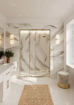 a bathroom with marble walls and flooring in white, gold and grey colors is shown