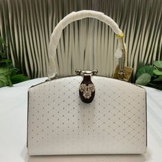 Beautiful Little Evening Purse. White Satin With Little Metal Dots In Shape Of 3 Dimensional Square, Lock Ornate With Crystals And The Metal Handle Carved. Inside Is One Pocket With Zipper. 5 Inches Tall, 6 1/2 Inches Wide. Very Elegant Little Purse. White Luxury Clutch Bag, Luxury White Clutch Bag, Luxury White Top Handle Evening Bag, White Top Handle Party Bags, White Top Handle Clutch For Party, White Satchel Evening Bag, White Party Satchel Bag, White Rectangular Evening Bag With Top Carry Handle, White Satchel Shoulder Bag For Party