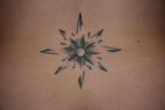 a tattoo on the back of a woman's stomach with arrows coming out of it