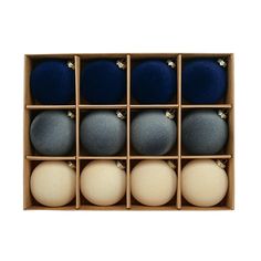 twelve blue and white balls in a wooden box