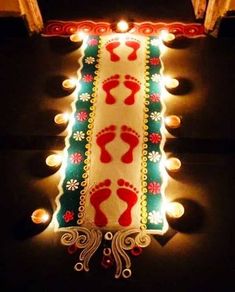 a lighted christmas tree with footprints and lights on the bottom is lit up in red, white and green