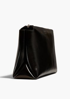 A lightweight pouch shaped by sculptural folds along the sides. The extended zipper closure allows allows for full access to the interior. Modern Evening Pouch With Zipper Closure, Leather Evening Bag With Zipper Pouch, Evening Pouch Clutch With Zipper Closure, Luxury Black Clutch With Zipper Pouch, Versatile Evening Bags With Zipper Pouch, Modern Black Clutch In Soft Leather, Versatile Evening Clutch With Zipper Closure, Rectangular Evening Pouch With Zipper Closure, Chic Business Clutch With Zipper Closure