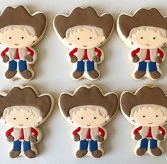 six cookies decorated with the image of a cowboy