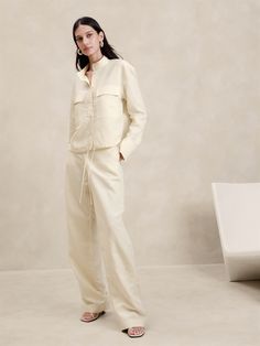 A relaxed take on utility styles, this drawstring top Is cut from a beautiful Italian fabric that blends luxurious linen with soft, silky  TENCEL™ lyocell.  Layer it as a shirt jacket or stye it on its own.  Relaxed fit with a dropped shoulder.  Fabric from Italy's Olimpias mill.  Sustainability: Made with TENCEL™ lyocell, a sustainably sourced fiber from responsibly-harvested trees.  Banded collar with button front.  Chest pockets.  Drawstring hem.  Unlined.  Relaxed fit.  Long sleeves.  Hip length.  Model: Size S, 5'10" (178cm). Unstructured Linen Shirt, Daywear Linen Shirt With Roll-up Sleeves, Luxury Linen Button-up Shirt, Luxury Linen Long-sleeve Outerwear, Luxury Garment Washed Button-up Shirt, Drawstring Top, Italian Fabric, Luxury Linen, Two Piece Dress