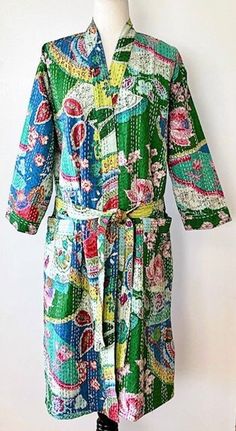 This delightful 100% cotton wrap kimono is a breath of fresh air.  A full kaleidoscope of bright colors like a blooming spring garden.  Constructed with high quality cotton, handmade and kantha embroidered.  Designed as a traditional short kimono with an extra wide front band showcasing kantha embroidery created by hand. This embroidery is also carried throughout the garment. Special detailing is noticable throughout the garment,  double width hem panel, etc.  The bright color pallet works well Traditional Blue Floral Print Kimono, Traditional Blue Floral Kimono, Multicolor Patchwork Kimono For Spring, Multicolor Kimono With Floral Embroidery, Spring Cotton Kimono With Floral Embroidery, Multicolor Floral Embroidered Kimono For Festivals, Floral Embroidered Multicolor Kimono For Festivals, Bohemian Blue Kimono With Floral Embroidery, Blue Bohemian Kimono With Floral Embroidery