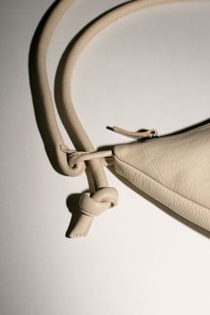 A soft form crescent shaped bag in vegetable tanned semi-aniline cowhide, 100% leather. Shown here with the strap doubled, but can be lengthened. 11" wide, 7" tall at center, 2" deep with a 40" total strap length. Zip closure. Beige Leather Hobo Bag With Adjustable Strap, Leather Baguette Bag With Smooth Grain For Daily Use, Leather Shoulder Bag With Round Handle For Daily Use, Everyday Leather Baguette Bag With Smooth Grain, Modern Leather Baguette Bag With Leather Handles, Beige Leather Crossbody Hobo Bag, Versatile Leather Baguette Bag With Leather Handles, Leather Hobo Bag With Round Handle For Travel, Leather Baguette Bag With Leather Handles