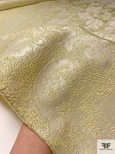 This floral textured metallic brocade in light yellow, silver, and champagne is a luxurious and opulent fabric that is perfect for creating a show-stopping look. The light yellow color combined with the metallic silver and champagne threads creates a subtle and sophisticated shimmer, while the floral pattern adds a touch of romance. SKU: 16509 Content: Polyester / Lurex Color: Light Yellow / Silver / Champagne Width: 51 inches Elegant Brocade Fabric For Formal Occasions, Festive Cream Elegant Fabric, Elegant Jacquard Fabric For Evening, Festive Jacquard Fabric, Elegant Festive Gold Fabric, Elegant White Festive Fabric, Elegant Gold Fabric For Formal Occasions, Elegant Gold Fabric For Festive Season, Elegant White Fabric For Festive Season