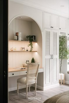 a white desk and chair in a room with built - in closets, bookshelves and shelves