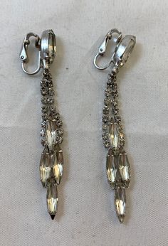 "Offering a pair of vintage earrings with four larger rhinestones at the bottom in a diamond pattern, and one large rhinestone at the top where the clip on is. In great condition, the earrings were created by Weiss.  Measures approximately 3\" in length. The Vintage Crate:  Located in Arnprior, Ontario, serving worldwide. Interested in more unique items, check out https://www.etsy.com/shop/TheVintageCrateTVC" Vintage Crate, Dangly Earrings, Unique Items, Vintage Rhinestone, Diamond Pattern, Vintage Earrings, The Vintage, Clip On, Ontario