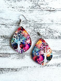 Choose from a beautiful set of earrings or a pendant necklace on Black adjustable cotton. Stunning vibrant giving tree engraved on a tear drop style shape.  Pattern is fairly consistent with vibrant colors placement can vary with each pair due to the handmade nature.  A bit larger and still whimsically lightweight.  Our earrings have the option of ear wire ( most popular ) , Dangle stud and clip on option.   Earring measures 1.3" Length  (pendant only) Our metals are nickel free , lead free stainless steel, iron or alloy, finishes vary depending on style choice. Multicolor Hypoallergenic Teardrop Earrings, Hypoallergenic Multicolor Teardrop Earrings, Multicolor Hypoallergenic Teardrop Earrings As Gift, Multicolor Teardrop Earrings For Gift, Multicolor Nickel-free Teardrop Earrings For Gifts, Multicolor Teardrop Pendant Earrings For Gift, Multicolor Dangle Teardrop Earrings As Gift, Multicolor Dangle Teardrop Earrings For Gift, Watercolor And Ink