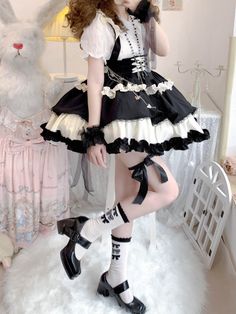 This stunning Lolita skirt features a charming black and white color scheme, accentuated by a lace-up front and a high waist design for a flattering fit. The detachable straps add a versatile touch, allowing you to customize your look. Embrace the sweet and elegant Lolita style with this beautiful skirt that is perfect for any occasion.   	 		 			Size 			S 			M 			L 		 		 			Waist 			58-82 			64-88 			72-94 		 		 			Full Length 			43 			44 			45 		 		 			Hem Circumference 			426 			426 			426 Harajuku Style Black Skirt For Costume Party, White Harajuku Skirt With Ruffles, White Harajuku Style Ruffled Skirt, Harajuku Style Black Ruffled Bottoms, Cute Black Mini Skirt For Party, Cute Fitted Black Skirt, Cute Black Bottoms For Party, Cute Black Skirt With Ruffles, Cute Black Mini Skirt For Spring