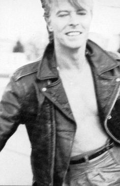 a black and white photo of a man in leather jacket