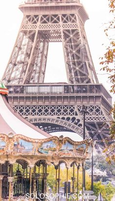 the eiffel tower in paris, france is seen from behind an amusement park