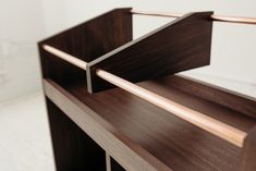 a close up view of a wooden shelf with metal bars on the top and bottom