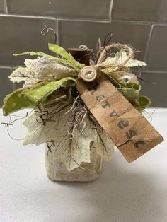 a bottle with some leaves and a tag attached to it