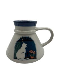 a ceramic pitcher with a cat on it