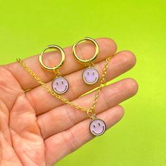 If you're looking for a cute jewellery set that you won't find anywhere else then you've just found it  The perfect little treat for yourself or the pickle in your life ☮️ - stainless steel (tarnish free) gold tone 1.5cm huggie hoop earrings - gold tone metal & enamel mini lilac smiley face charms  - 18 inch gold plated chain with lobster claw clasp  Made by us pickles to make you smile! 🧡 FREE 2nd class delivery 🚚 Smiley Face Earrings, Smiley Face Necklace, Cute Jewellery, Earrings Matching, Face Necklace, Face Earrings, Jewellery Set, Cool Necklaces, Huggie Hoop Earrings