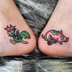 two people with tattoos on their feet and one has a small pig in the middle