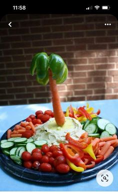 a plate filled with vegetables and carrots on top of a blue cloth covered table