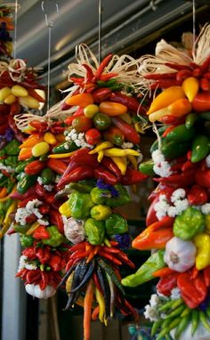 many different types of vegetables hanging from strings