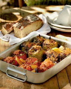 a casserole dish filled with vegetables and bread