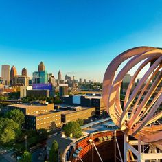 an aerial view of a city with tall buildings and a large metal object in the foreground