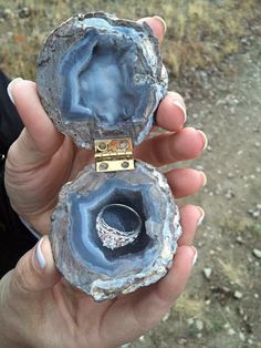 a person holding two pieces of rock with the words this proposal on it