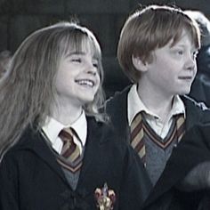 two young harry potters are smiling and looking at something in front of the camera