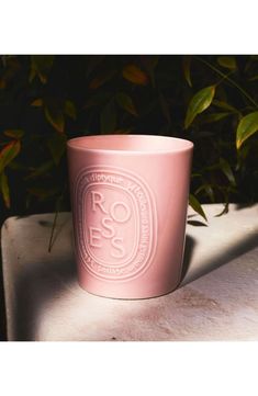 a pink coffee cup sitting on top of a table