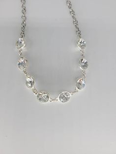 "Unique glass crystal charm Necklace with a silver chain. Great for gifts for weddings bride bridesmaids mothers day or just to say your special. Has a 3\" extension with a lobster claw clasp.  Measurements: chain 18\" charms 1/4\" extensions 3\"" Sparkling Rhinestone Necklace For Gift, Sparkling Rhinestone Necklace For Anniversary, Dazzling Crystal Rhinestone Necklace As Gift, Dazzling Sparkling Rhinestone Necklace For Anniversary, Gift Crystal Rhinestone Necklace With Sparkling Stones, Gift Rhinestone Crystal Necklace With Sparkling Stones, Sparkling Crystal Rhinestone Necklace Gift, Glamorous Crystal Rhinestone Necklace As Gift, White Rhinestone Round Necklace For Party