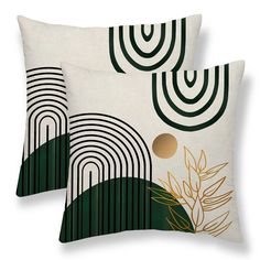 two green and white decorative pillows on a white background with gold circles in the middle