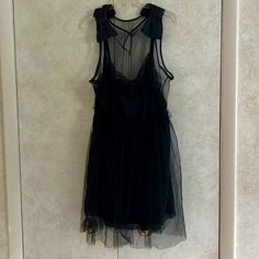 Xxo Lbd Highly Styled With Netting. Content Is Nylon And Polyester. Bows At Shoulders. Back Has Only Netting. Elastic At Waist Stretches. Length To End Of Netting Is 42”. Dress Is 4” Shorter. Armpit To Armpit 24”. Waist Stretches To 18”. Zipper On Side. Machine Wash. Perfect For A Special Occasion. Black Sheer A-line Dress, Black Sleeveless Mesh Dress For Spring, Black Sleeveless Mesh Dress For Night Out, Black Sleeveless Mesh Dress For Date Night, Black Sleeveless Sheer Dress, Black Sleeveless Mesh Dress For Evening, Black Knee-length Mesh Dress For Summer, Black Sheer Sleeveless Dress, Black Mesh Mini Dress For Summer