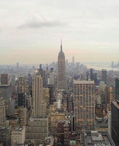 an aerial view of new york city with skyscrapers and the empire building in the background