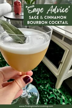 someone is holding up a glass with a beverage in it and the caption says sage advice sage & cinnamon bourbon cocktail