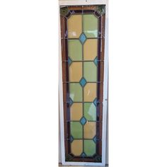 an old stained glass window with brown trim