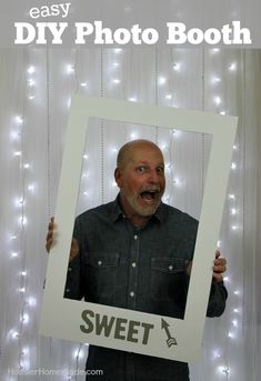 a man holding up a photo booth sign with the words easy diy photo booth