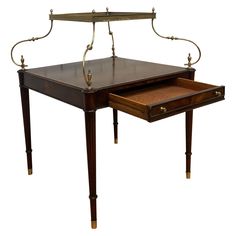 an antique desk with a drawer underneath it