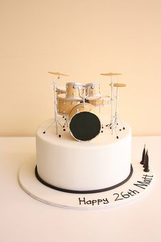 a birthday cake with a drum set on top