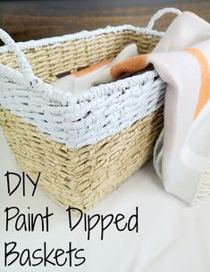 a wicker basket with paint dipped handles and a white towel in the bottom that says diy painted baskets