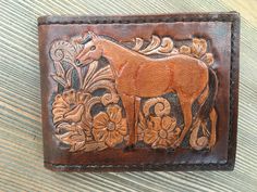 "A Men's Hand-Made, Hand-Carved, Genuine Leather, Custom Western Bi-fold Wallet This one is a tailored design for the Cowboy or Horse Lover Outfitted with a beautiful traditional Equestrian Theme Design Original sold. Now relisted Custom made to order ... Embodied with fine outstanding workmanship Only takes 7-10 days to fabricate. Perfect opportunity to personalize it at no extra cost DETAILS : - Premium Genuine Herman Oak Calf Leather--100% Made In America - Hand Saddle-stitched - can be laced Hand Tooled Bifold Wallet As Gift, Artisan Hand Tooled Leather Trifold Wallet, Western Leather Wallet, Custom Hand-tooled Trifold Wallet, Rectangular Leather Wallet With Hand Tooling, Western Style Brown Leather Wallet, Custom Hand-tooled Rectangular Trifold Wallet, Money Storage, Deer Theme