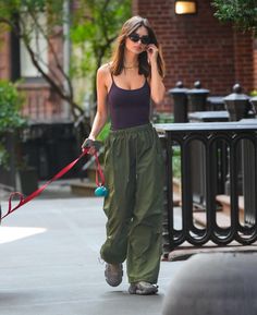 a woman walking her dog while talking on the phone