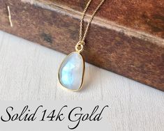 Rainbow Moonstone Necklace, Solid 14k Gold Pendant, June Birthstone, Real Gold Moonstone Jewelry , Birthday gift for her, Mother's Day Gift This classic minimalist necklace features a beautiful flashy rainbow moonstone free form pendant bezeled in solid 14k gold. The moonstone pendant is suspended from a dainty solid 14k gold cable chain that can adjust to three popular lengths, 16, 17 or 18 inches, whenever you needed. This is a slightly larger version of one of our best sellers for those that Bridal Party Jewelry, Rainbow Moonstone Necklace, Solid Gold Necklace, Necklace Chain Lengths, Jewelry Birthday, June Birthstone, Moonstone Necklace, Moonstone Jewelry, Moonstone Pendant