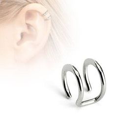 an ear piercing is shown with two silver rings