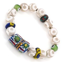 The Eye of Colors Bracelet is a beautiful piece of jewelry that is handcrafted using a variety of high-quality materials. The bracelet features White Nepal Agate stone beads, which are known for their calming and grounding properties. These beads are paired with Handmade paintings African beads, which add a pop of color and texture to the bracelet. The green evil eye beads are believed to provide protection against negative energy and promote good luck and prosperity. The Eye of Colors Bracelet Spiritual Agate Beaded Bracelets With Colorful Beads, Handmade White Agate Beaded Bracelets, Multicolor Large Beaded Bracelets For Meditation, Traditional Agate Hand-strung Bracelets, Bohemian Agate Beaded Bracelets With Large Beads, Bohemian Beaded Bracelets With Large Agate Beads, Agate Beaded Bracelet With Large Beads, Traditional Agate Round Bead Bracelets, Spiritual Agate Beaded Bracelets With Large Beads